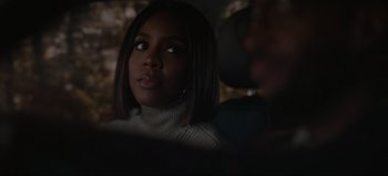 Movie still from “The Curse of Bridge Hollow” (2022), directed by Jeff Wadlow – A woman sitting in front of a camera in the dark; Close Up shot, Over the shoulder angle