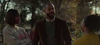 Movie still from “The Curse of Bridge Hollow” (2022), directed by Jeff Wadlow – A man wearing a brown jacket and a green sweater; Medium shot, Over the shoulder angle