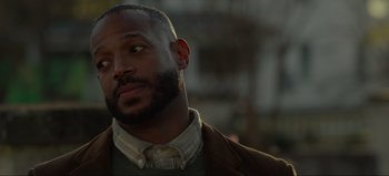 Movie still from “The Curse of Bridge Hollow” (2022), directed by Jeff Wadlow – A person wearing a suit and tie; Close Up shot, Low angle