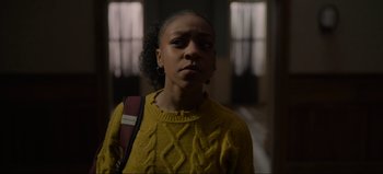 Movie still from “The Curse of Bridge Hollow” (2022), directed by Jeff Wadlow – A woman in a yellow sweater is standing in front of a window; Close Up shot, Over the shoulder angle