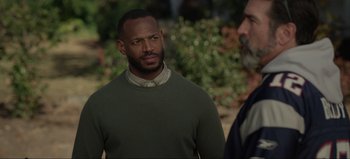 Movie still from “The Curse of Bridge Hollow” (2022), directed by Jeff Wadlow – A man in a green sweater and a man in a gray sweater; Close Up shot, Over the shoulder angle