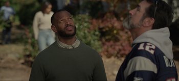 Movie still from “The Curse of Bridge Hollow” (2022), directed by Jeff Wadlow – A man in a green sweater looking up at the sky; Close Up shot, Over the shoulder angle