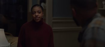 Movie still from “The Curse of Bridge Hollow” (2022), directed by Jeff Wadlow – A woman in a red sweater is standing in front of a mirror; Close Up shot, Over the shoulder angle