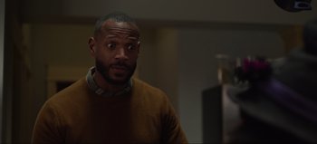 Movie still from “The Curse of Bridge Hollow” (2022), directed by Jeff Wadlow – A person wearing a brown sweater; Close Up shot, Over the shoulder angle