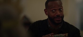 Movie still from “The Curse of Bridge Hollow” (2022), directed by Jeff Wadlow – A person holding a cup of coffee; Close Up shot, Over the shoulder angle