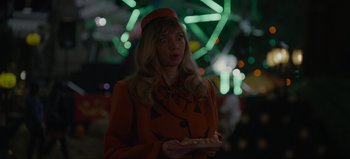 Movie still from “The Curse of Bridge Hollow” (2022), directed by Jeff Wadlow – A woman holding a plate of food in her hands; Medium shot, Over the shoulder angle
