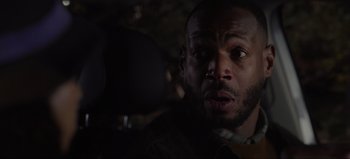 Movie still from “The Curse of Bridge Hollow” (2022), directed by Jeff Wadlow – A man's face in the dark; Close Up shot, Over the shoulder angle