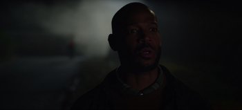 Movie still from “The Curse of Bridge Hollow” (2022), directed by Jeff Wadlow – A person in a dark room; Close Up shot, Over the shoulder angle