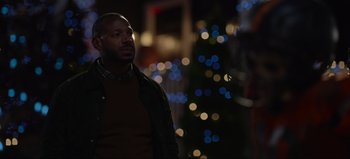 Movie still from “The Curse of Bridge Hollow” (2022), directed by Jeff Wadlow – A man standing in front of a christmas tree; Close Up shot, Over the shoulder angle