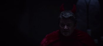 Movie still from “The Curse of Bridge Hollow” (2022), directed by Jeff Wadlow – An older man wearing a red devil costume; Close Up shot, High angle