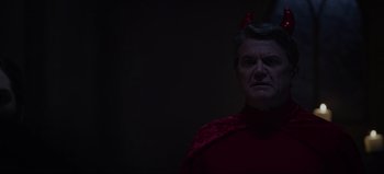 Movie still from “The Curse of Bridge Hollow” (2022), directed by Jeff Wadlow – An older man wearing a red shirt and a red bow; Close Up shot, Over the shoulder angle