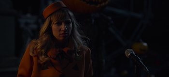 Movie still from “The Curse of Bridge Hollow” (2022), directed by Jeff Wadlow – A woman wearing a hat and a pumpkin costume; Close Up shot, Over the shoulder angle