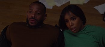 Movie still from “The Curse of Bridge Hollow” (2022), directed by Jeff Wadlow – A man and a woman sitting next to each other; Close Up shot, High angle