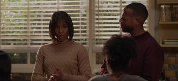 Movie still from “The Curse of Bridge Hollow” (2022), directed by Jeff Wadlow – A group of people sitting around a table; Medium shot, Over the shoulder angle