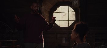 Movie still from “The Curse of Bridge Hollow” (2022), directed by Jeff Wadlow – A man and a woman are talking in front of a window; Medium shot, Over the shoulder angle