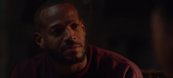 Movie still from “The Curse of Bridge Hollow” (2022), directed by Jeff Wadlow – A person wearing a red shirt; Close Up shot, Over the shoulder angle