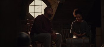 Movie still from “The Curse of Bridge Hollow” (2022), directed by Jeff Wadlow – A man sitting on a chair next to another man; Medium shot, Over the shoulder angle