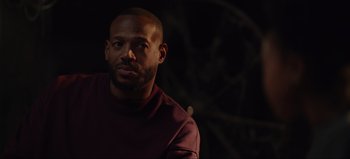 Movie still from “The Curse of Bridge Hollow” (2022), directed by Jeff Wadlow – A person wearing a maroon shirt; Close Up shot, Over the shoulder angle