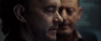Movie still from “The Da Vinci Code” (2006), directed by Ron Howard – A man's face with another man in the background; Close Up shot, Over the shoulder angle
