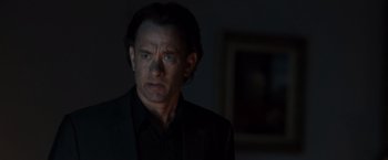 Movie still from “The Da Vinci Code” (2006), directed by Ron Howard – A man in a black shirt and black jacket looking at the camera; Close Up shot, Over the shoulder angle