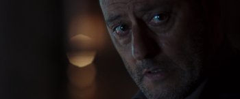 Movie still from “The Da Vinci Code” (2006), directed by Ron Howard – A man's face in the dark; Extreme Close Up shot, Over the shoulder angle