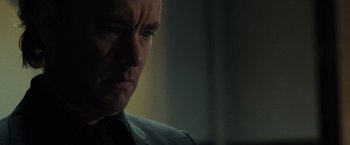 Movie still from “The Da Vinci Code” (2006), directed by Ron Howard – A person wearing a suit and tie; Close Up shot, Over the shoulder angle