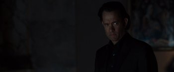 Movie still from “The Da Vinci Code” (2006), directed by Ron Howard – A man in a black shirt is looking at the camera; Close Up shot, Over the shoulder angle