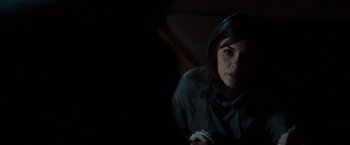 Movie still from “The Da Vinci Code” (2006), directed by Ron Howard – A woman sitting in a dark room holding a cell phone; Close Up shot, Over the shoulder angle