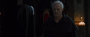 Movie still from “The Da Vinci Code” (2006), directed by Ron Howard – A man standing in front of another man in a dark room; Close Up shot, Over the shoulder angle