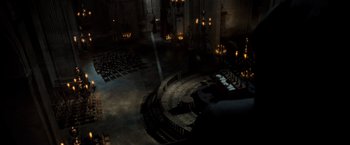 Movie still from “The Da Vinci Code” (2006), directed by Ron Howard – An image of an empty church with lights in the background; Extreme Wide shot, High angle