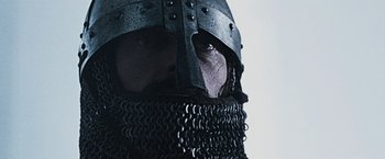 Movie still from “The Da Vinci Code” (2006), directed by Ron Howard – A person wearing a helmet and chain mail; Close Up shot, Low angle