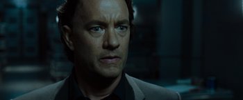 Movie still from “The Da Vinci Code” (2006), directed by Ron Howard – A man in a black shirt and a black tie; Close Up shot, Over the shoulder angle