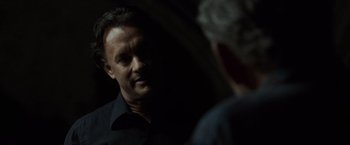 Movie still from “The Da Vinci Code” (2006), directed by Ron Howard – A man standing in front of another man in a dark room; Close Up shot, Over the shoulder angle