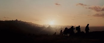 Movie still from “The Da Vinci Code” (2006), directed by Ron Howard – The sun is setting in the distance over a field; Extreme Wide shot, Low angle