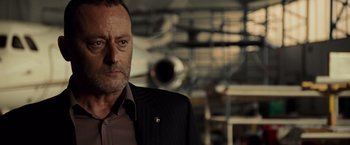 Movie still from “The Da Vinci Code” (2006), directed by Ron Howard – A person wearing a suit and tie; Close Up shot, Over the shoulder angle