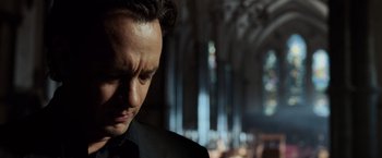 Movie still from “The Da Vinci Code” (2006), directed by Ron Howard – A person wearing a suit and tie; Close Up shot, Low angle