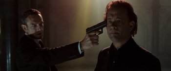 Movie still from “The Da Vinci Code” (2006), directed by Ron Howard – A man holding a gun up to his head; Close Up shot, Over the shoulder angle