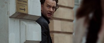 Movie still from “The Da Vinci Code” (2006), directed by Ron Howard – A person leaning against a wall; Close Up shot, Over the shoulder angle