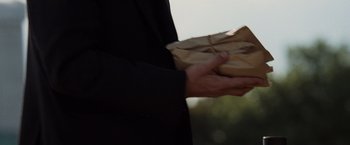 Movie still from “The Da Vinci Code” (2006), directed by Ron Howard – A person holding a brown paper bag in their hands; Extreme Close Up shot, High angle