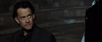 Movie still from “The Da Vinci Code” (2006), directed by Ron Howard – A person wearing a suit and tie; Close Up shot, Over the shoulder angle