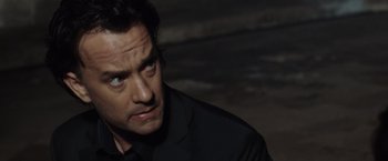 Movie still from “The Da Vinci Code” (2006), directed by Ron Howard – A person wearing a black shirt; Close Up shot, Over the shoulder angle