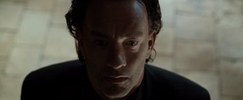 Movie still from “The Da Vinci Code” (2006), directed by Ron Howard – A man's face in a dark room; Close Up shot, Low angle