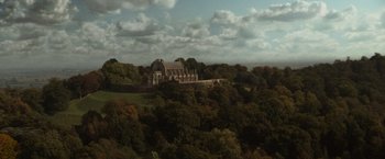 Movie still from “The Da Vinci Code” (2006), directed by Ron Howard – An aerial view of a large building on top of a hill; Extreme Wide shot, High angle
