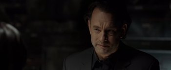 Movie still from “The Da Vinci Code” (2006), directed by Ron Howard – A person wearing a suit and tie; Close Up shot, Over the shoulder angle