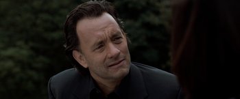 Movie still from “The Da Vinci Code” (2006), directed by Ron Howard – A person wearing a suit and tie; Close Up shot, Over the shoulder angle