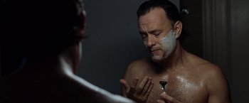 Movie still from “The Da Vinci Code” (2006), directed by Ron Howard – A man shaving his face in front of a mirror; Close Up shot, Over the shoulder angle