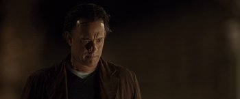 Movie still from “The Da Vinci Code” (2006), directed by Ron Howard – A person wearing a brown jacket; Close Up shot, Low angle