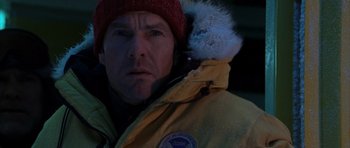 Movie still from “The Day After Tomorrow” (2004), directed by Roland Emmerich – A person wearing a jacket and a hat; Close Up shot, Over the shoulder angle