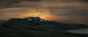 Movie still from “The Day After Tomorrow” (2004), directed by Roland Emmerich – A house on top of a green hill with a sky background; Extreme Wide shot, Low angle