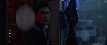 Movie still from “The Day After Tomorrow” (2004), directed by Roland Emmerich – A man standing in a dark room next to an umbrella; Close Up shot, Low angle